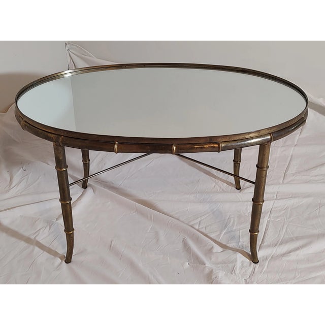 A Solid Brass Vintage Accent Table, Circa 1970's presents an elegant and unique presentation with a Mirrored Top and Faux...