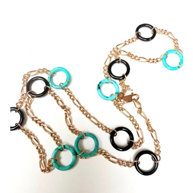 A refined Italian-crafted station necklace featuring alternating onyx and turquoise circles set in solid 14-karat yellow...
