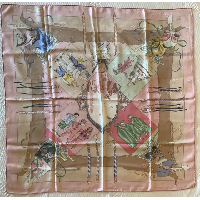 This is a vintage Hermès "Le Carnaval de Venise" silk scarf designed by Hubert de Watrigant in 1993, featuring a soft pink...