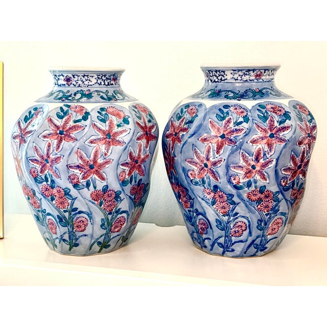 Vintage Chinese hand-painted vases, a pair. Elegant and mirror-matched, this pair of vintage ceramic vases features soft...