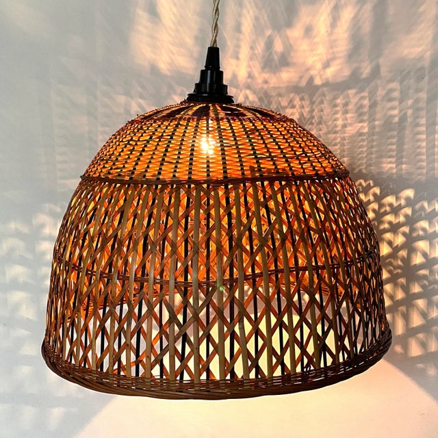 Hand-crafted mid century wicker lantern. Natural wicker color with handsome woven black highlights. Includes new wiring...