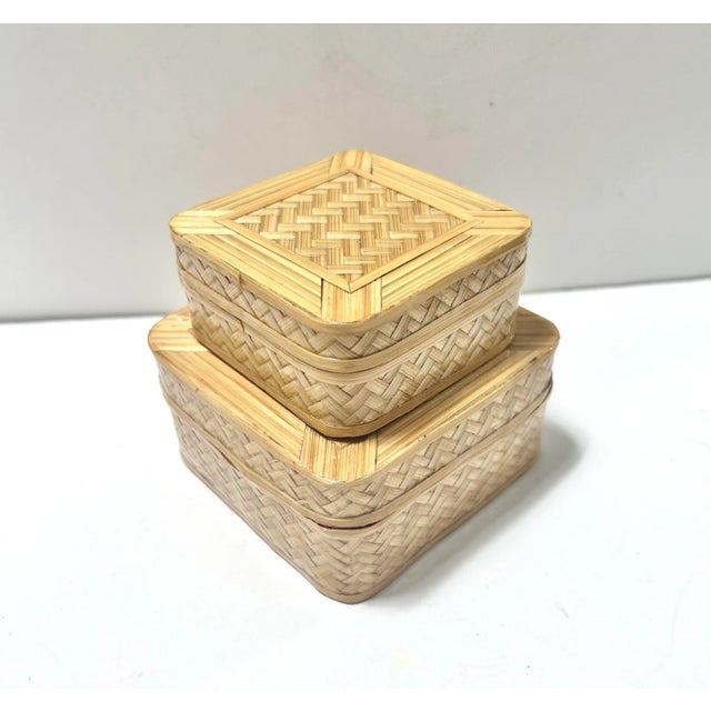A beautifully crafted pair of 1970s handwoven bamboo trinket boxes featuring tight herringbone weave and contrasting red...