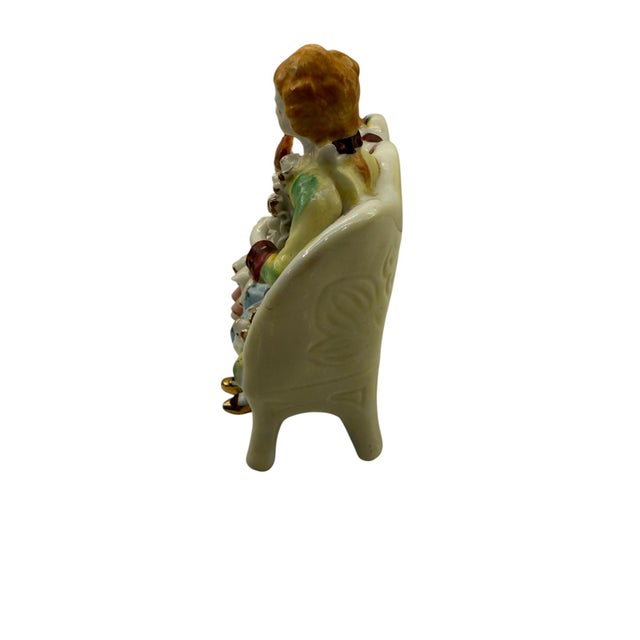 Victorian Boy & Girl on Bench Bone China Figurine These seated figures sport vibrant colors. The figures are dressed in...