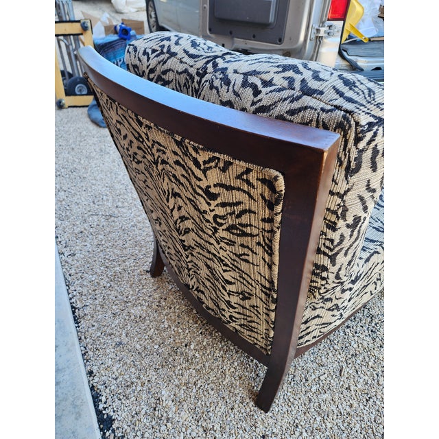 Large scale upholstered chair with charming faux tiger fabric and back cushion. This would make a great occasional chair...