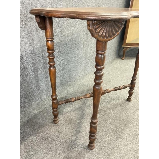 A beautifully timeworn antique entry table with rich character and sculptural detail, dating to the late 19th century....