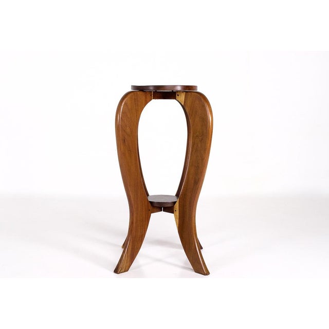 Art Deco acacia wood plant stand, structured around two round solid wood shelves. Dating from the 1930s, its robust design...