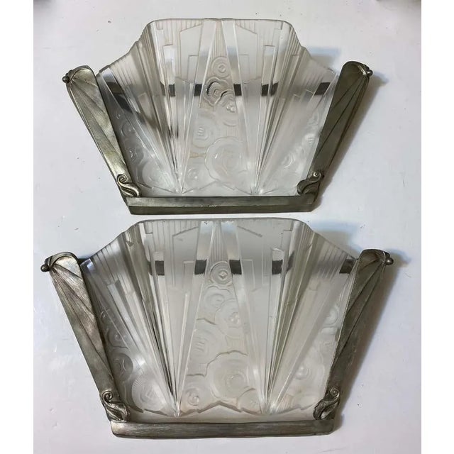 Stunning pair of French Art Deco sconce signed by Hettier Vincent. With clear frosted glass shades having intricate...
