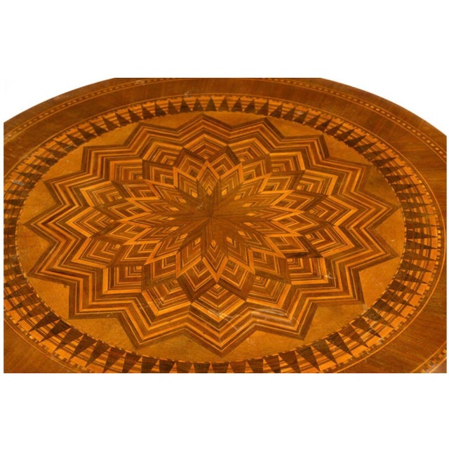 19th Century Italian Round Parquetry Pedestal Table With Drawer. Table top features fine wood veneers arranged in a...