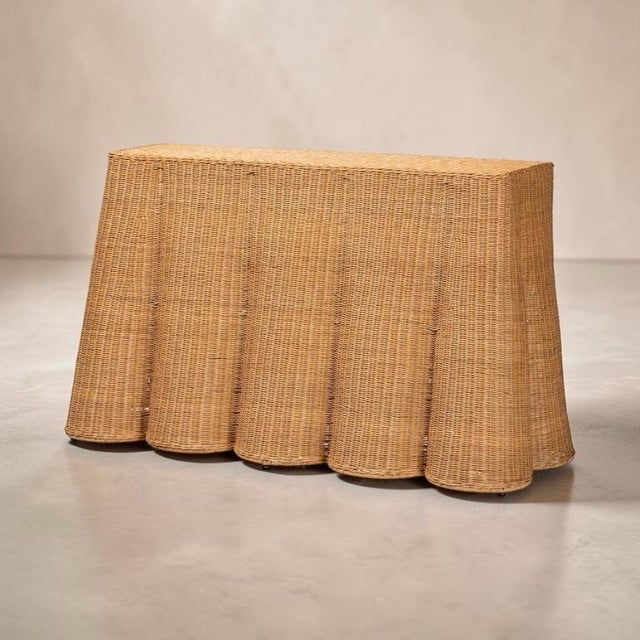 Handwoven rattan console table with a warm honey finish. Skirted undulating folds mimic draped fabric. Wonderful piece for...