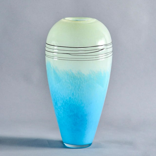 Circa 1980s tall art glass vase in blue and pale green with stringing detail at top. Unknown maker. Found in US.