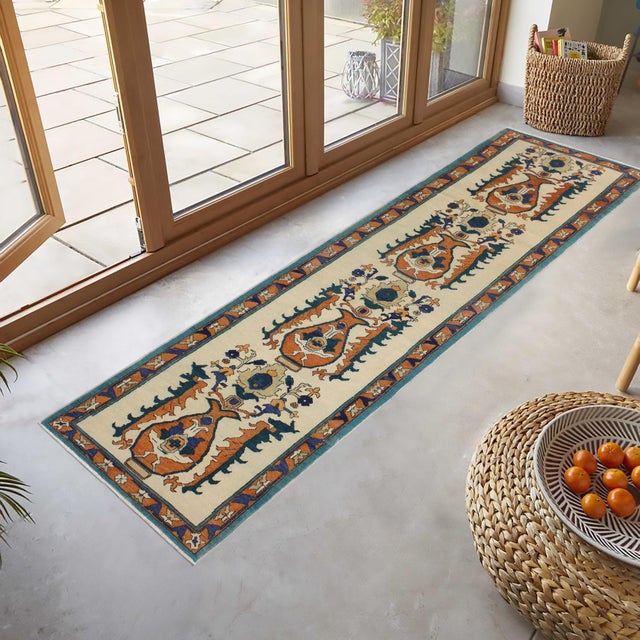 Enhance the ambiance of your home with this magnificent Persian-influenced Turkish hand-knotted rug made by skilled...