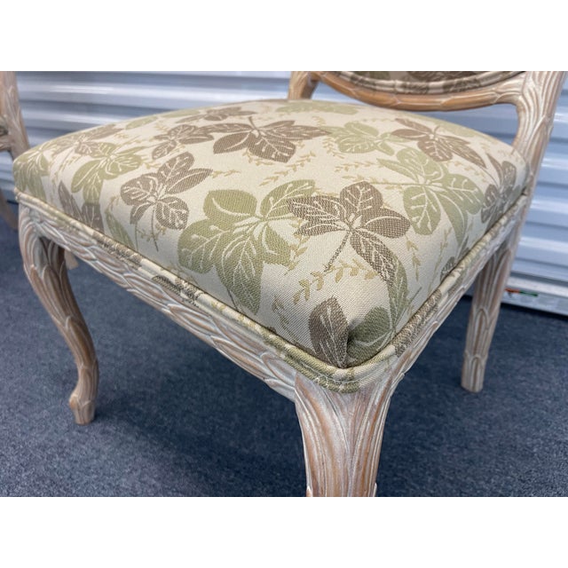 Charming pair of vintage faux bois side chairs featuring sculptural carved frames designed to mimic natural wood grain and...