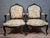 An elegant pair of Louis XV style armchairs, crafted from molded and carved wood with a black lacquer finish, resting on...