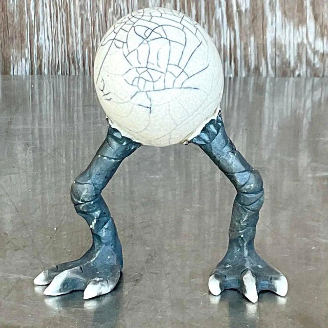 This Vintage Boho Raku Fired Egg Sculpture offers a striking, whimsical aesthetic, perfect for collectors and art lovers....