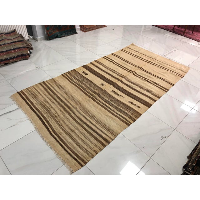 This is a vintage Turkish Anatolian kilim rug from the 1960s. The piece was hand-woven.