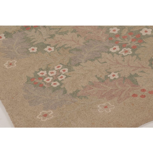 Handmade in wool, this antique hooked rug measures 6x9 and dates to circa 1920-1930. The design features a graceful floral...