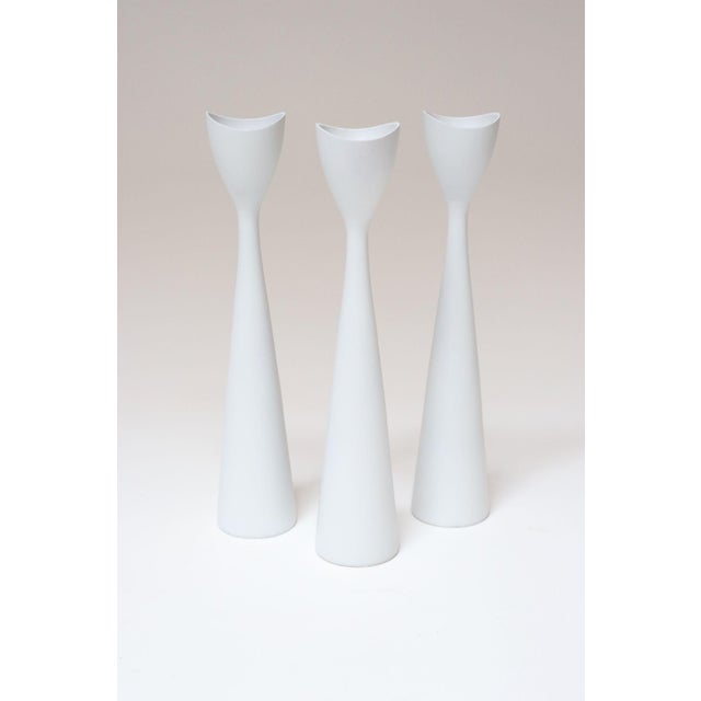 Set of three white candlesticks/holders by BRDR Bonfils of Denmark, ca. 1960s. Graceful design with elongated stems and...
