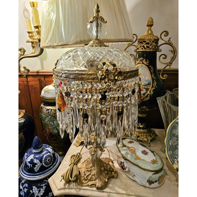 Illuminate your space with timeless elegance through this stunning vintage-style crystal table lamp. Featuring an ornate...