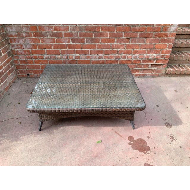 Oversized woven vinyl outdoor cocktail table with glass top. This piece was purchased brand new as part of a set from...