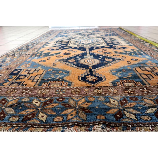 Indulge in the rich history and captivating beauty of the Handmade Antique Caucasian Shirvan Rug. Design and Aesthetics:...