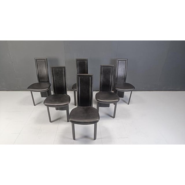 Set of 6 black italian leather high back dining chairs. Beautiful sleek and timeless design with the backrest continuing...