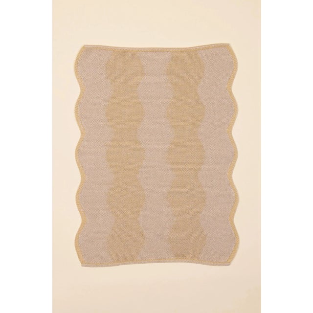 With its charming wavy edges, this sustainable yellow knitted table mat adds a playful touch to your dining table. The...