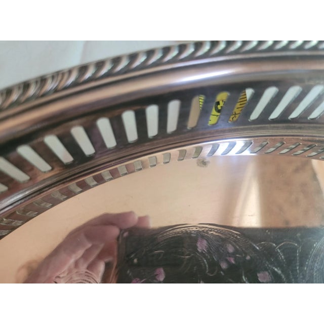 Add a touch of timeless elegance to your gatherings with this beautiful vintage silver-plated platter. This large, round...