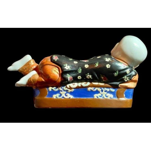 This outstanding, vintage mid 20th century piece is a traditional Chinese porcelain figural pillow (often historically...