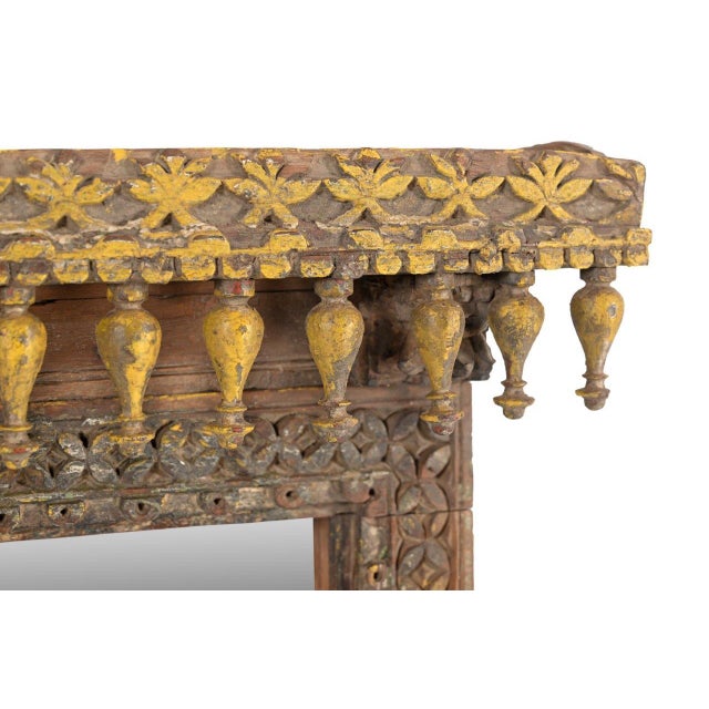 This Antique Indian Carved and Painted Teakwood Window Mirror is a stunning architectural piece crafted from an antique...