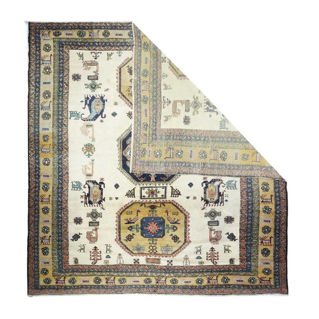 In a post-WWII Caucasian style, with three octagonal medallions dark slate blue and rusty goldenrod, with internal bird...