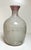 Lovely organic studio pottery vase in speckled slate color over accents of red sanger de boeuf style at top and as drip...