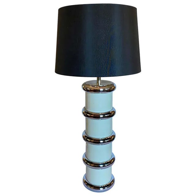 Mid-Century Modern chromed metal and enamel table lamp by Mutual Sunset Lamp Company. This tall round cylinder shaped lamp...