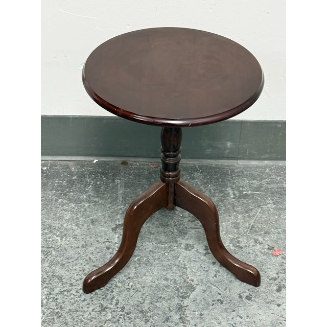 Design Plus Gallery presents a Round Dark Tripod Pedestal Accent Table from The Bombay Company. The circular wood top has...