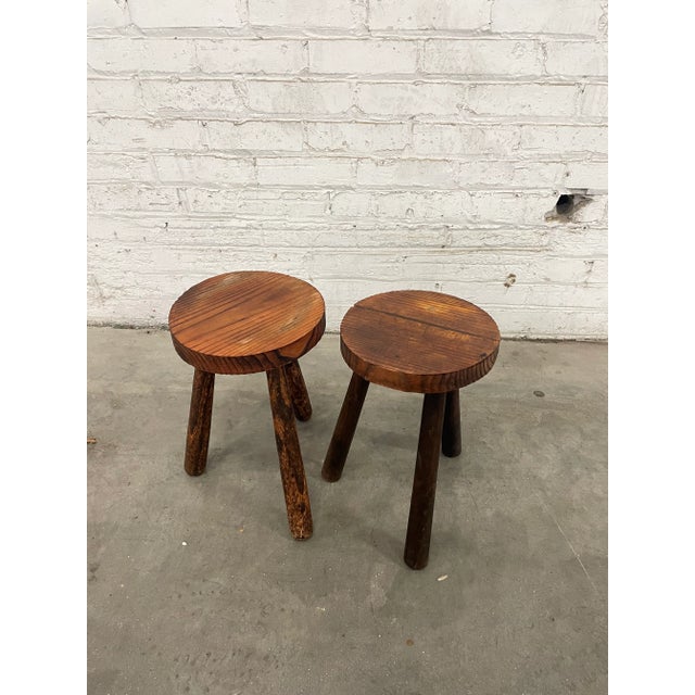A charming pair of European stools. Slightly tapered legs with faceted live-edge seats showcasing the wood grain....