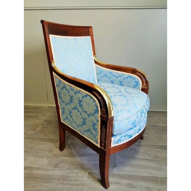 Empire style restoration, armchair Bergère, France circa 1815-1830. Solid mahogany wood with gold leaf details. Fully...