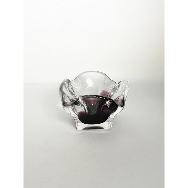 Italian art glass ashtray dating from the 1960s. Crafted from thick clear glass, the piece features a sculptural free-form...