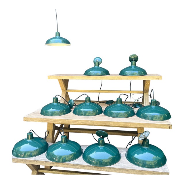 A rare set of 11 matching enamel barn pendants, perfect for large-scale residential or commercial design projects....