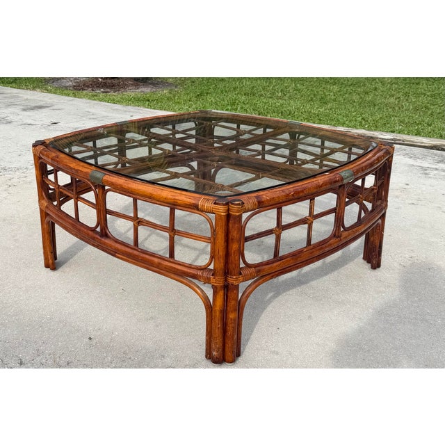 Vintage square coffee table crafted from bamboo and rattan in a rich tortoise finish. The substantial frame features...