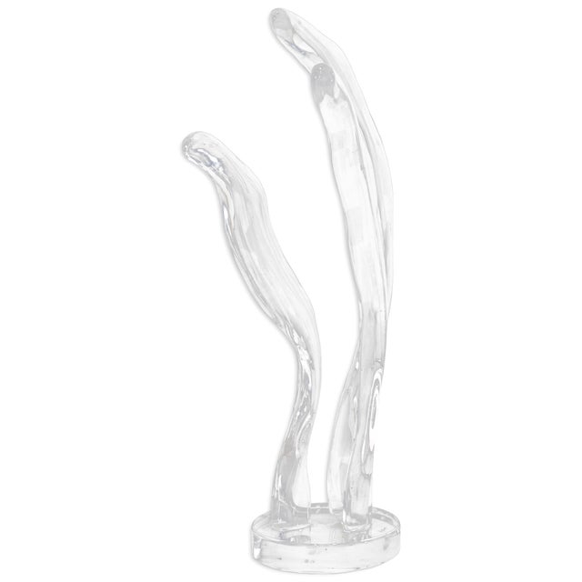 A striking large-scale abstract floor sculpture signed by Phelps, crafted from clear Lucite with fluid, organic wave-like...