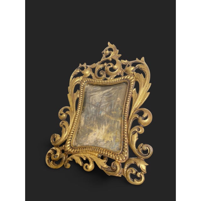 Superb rectangular gilt bronze frame mounted on two cabriole legs with a rear support. The front is richly chased with...