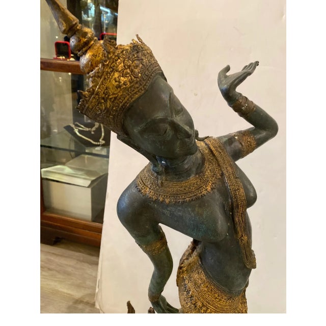 An antique bronze figure of a Thai dancer. The patinated and gilt bronze surface, all original. In very good condition...