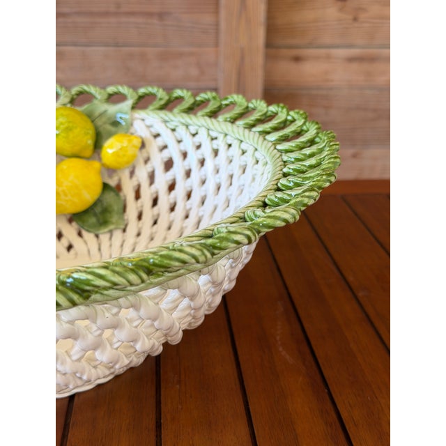 A beautifully handcrafted Italian ceramic centerpiece bowl by Lanzarin Ceramiche, featuring an intricately woven basket...