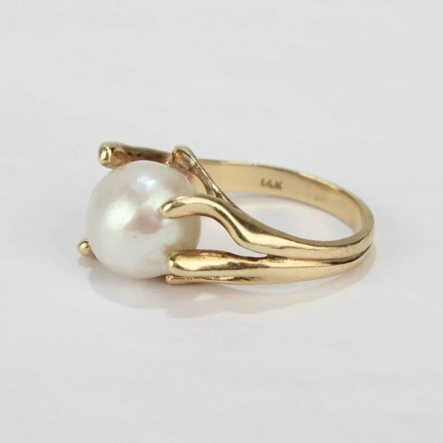 A fine, modernist 14k yellow gold and baroque pearl cocktail ring from the mid-20th century. Features a large baroque...