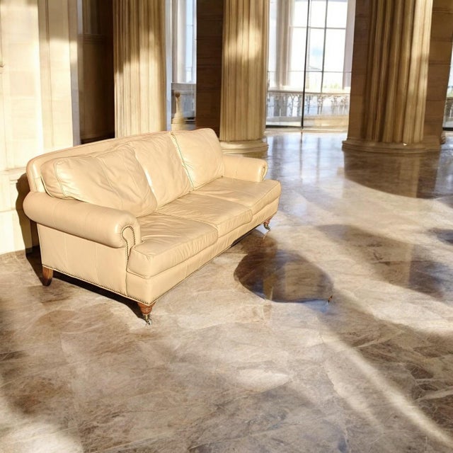 Luxurious Comfort: Sink into the supple, cream-colored leather of the Liz Claiborne sofa, offering both exceptional style...