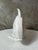 An elegant glazed earthenware sculpture with a crackle-like decoration depicting a stylized fish, typical of the Art Deco...