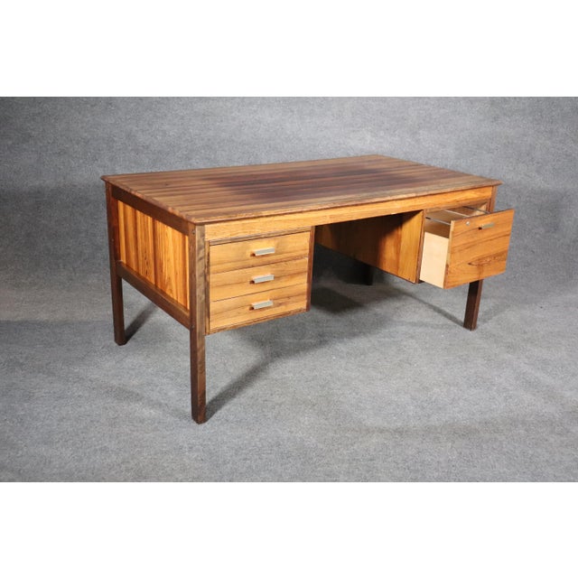 Stunning rosewood desk made by Farsø Stolefabrik For Maurice Villency. Deep wood grain throughout with accenting metal...