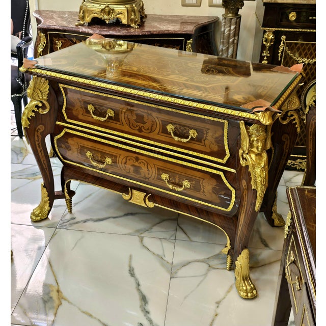 Make a striking statement with this grand French-style commode, an impressive piece that combines rich hardwood...
