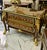 Make a striking statement with this grand French-style commode, an impressive piece that combines rich hardwood...