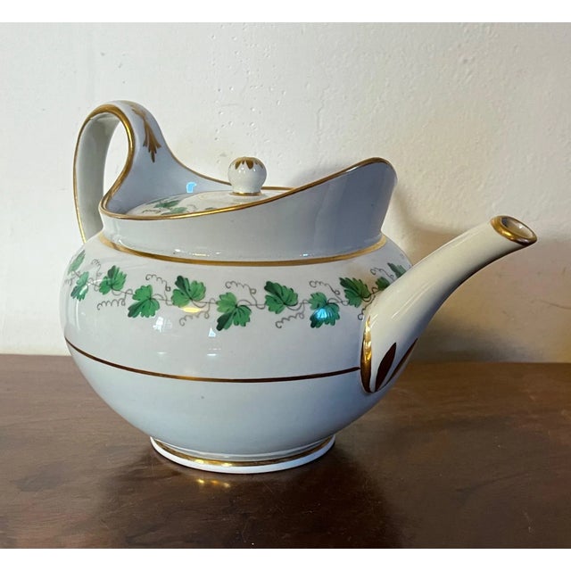 Antique early 19th century Vienna porcelain tea pot decorated with a green ivy garland and gilt monogram. Measures 5 1/4"...