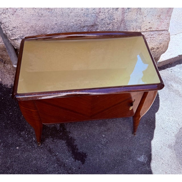 An elegant pair of vintage bedside tables with a refined taste, characterized by the soft, harmonious lines typical of...